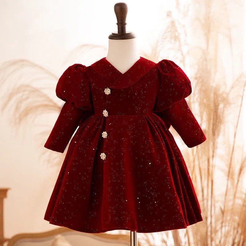 Burgundy glitter velvet girls party dress with a V-neck bodice, long puff sleeves and crystal flower buttons, front view, for birthday parties.