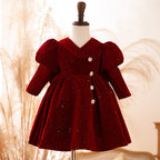 Burgundy sparkle velvet girls dress with long puff sleeves and jeweled buttons, designed for birthday parties.