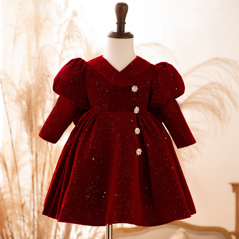 Burgundy velvet girls dress with a collared V-neck, jeweled buttons and long puff sleeves, designed for first birthdays.