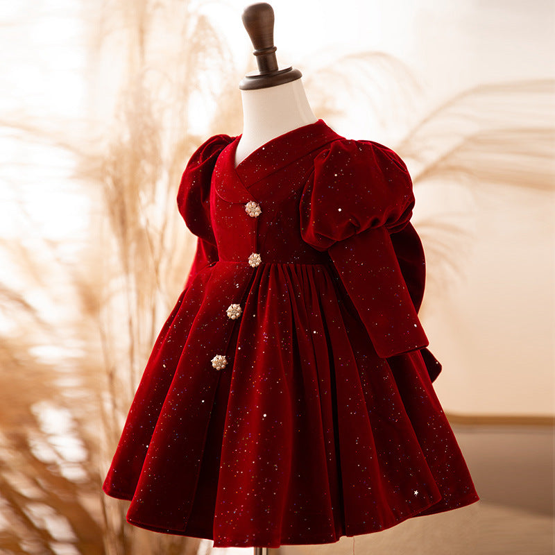 Burgundy velvet girls dress with puff sleeves and a pleated knee-length skirt, designed for holiday parties.
