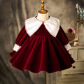 Burgundy velvet birthday girls dress with an ivory sailor collar and long sleeves, front view, for a birthday party.