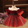 Burgundy velvet girls dress with pearl-trimmed ruffle collar, ruffle sleeves, black bow sash and sparkle tulle skirt, designed for Christmas and holiday parties.
