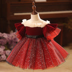 Burgundy velvet girls dress with pearl-trimmed ruffle collar, ruffle sleeves, black bow sash and sparkle tulle skirt, designed for Christmas and holiday parties.