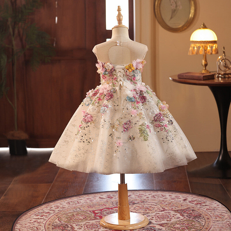 Champagne floral girls formal dress showing the ribbon lace-up corset back, back view, for flower girl duty at a wedding.