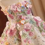 Close-up of the 3D flower appliqué and silver sequins on the champagne tulle bodice of the girls party dress.