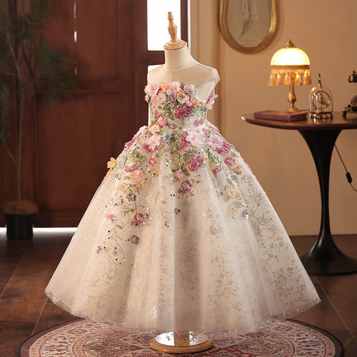 Champagne tulle girls gown with pink and blue 3D flowers cascading from the bodice, designed for weddings and birthdays.