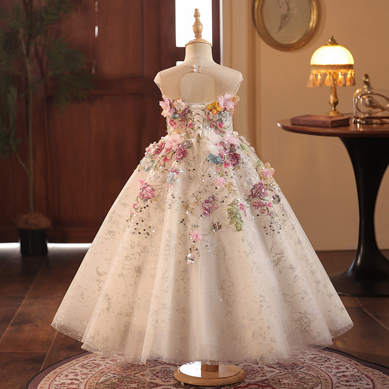 Champagne tulle girls gown with a keyhole button back and lace-up corset, designed for weddings and formal events.