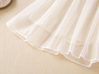 Layered hem of the cream chiffon girls A-line skirt, designed for birthday parties and fall photos.