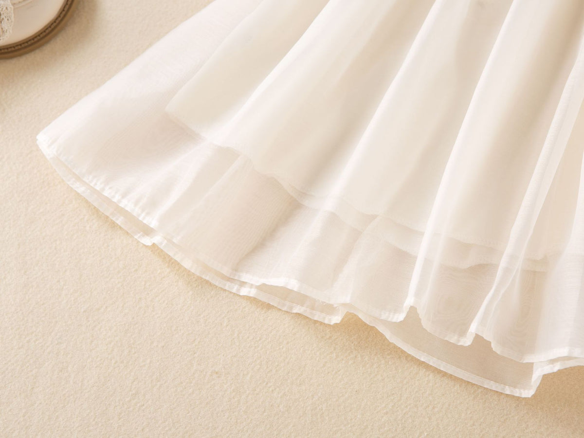 Layered hem of the cream chiffon girls A-line skirt, designed for birthday parties and fall photos.