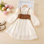 Back of the cream chiffon girls dress set showing the smocked elastic back of the brown faux leather vest, designed for parties.