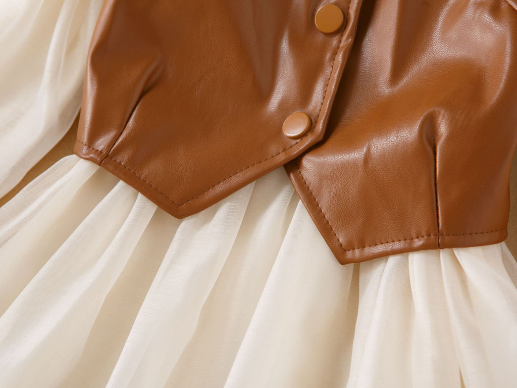 Button detail on the brown faux leather bustier vest of the cream chiffon girls dress set, designed for fall photos.