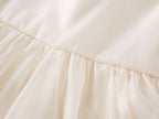 Gathered waist seam of the cream chiffon girls A-line dress, designed for parties and family photos.