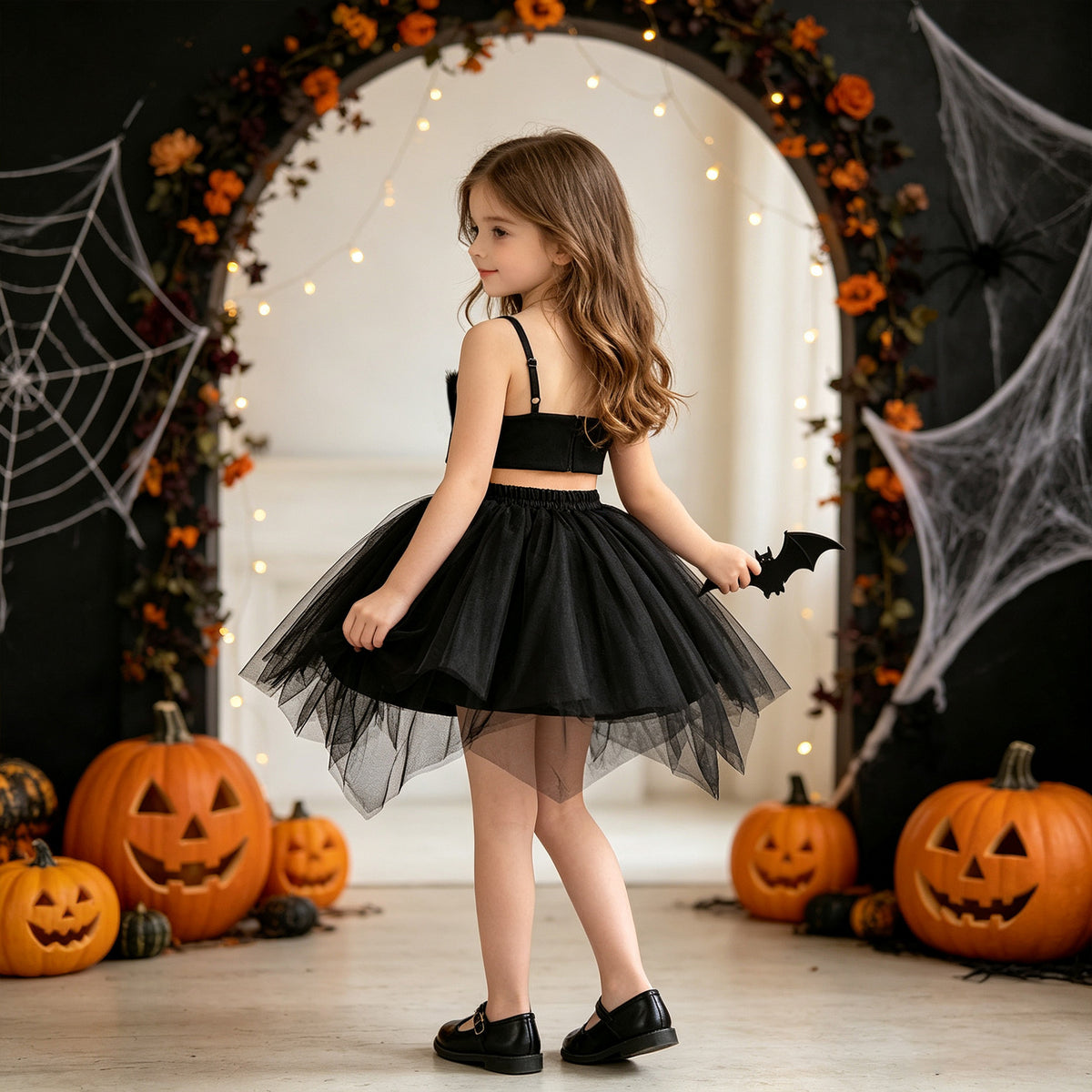 Black tulle girls two-piece set with a ruched crop top and layered tutu skirt, designed for Halloween parties, view 3