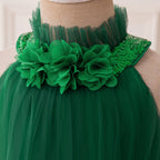 Dark green tulle girls dress with pleated high collar and fabric flowers at the neck, designed for holiday parties.