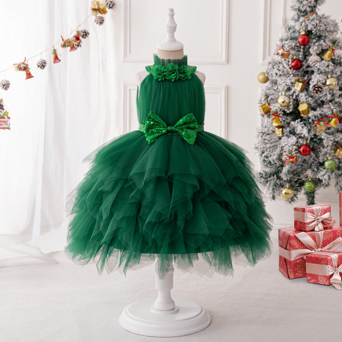 Dark green tulle girls dress with flower-trimmed halter neck, sequin bow waist and tiered tutu skirt, designed for Christmas parties.