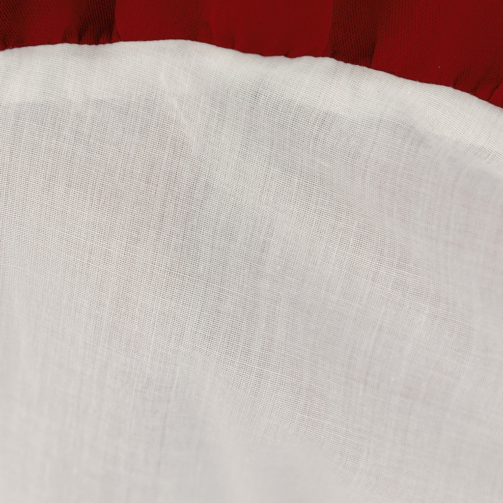 Close-up of the soft white lining inside the deep red girls dress.