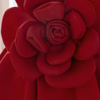 Detail of the layered petals on the rose appliqué of the deep red girls dress.