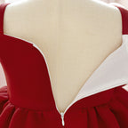 Close-up of the back zipper and white lining of the deep red girls dress.