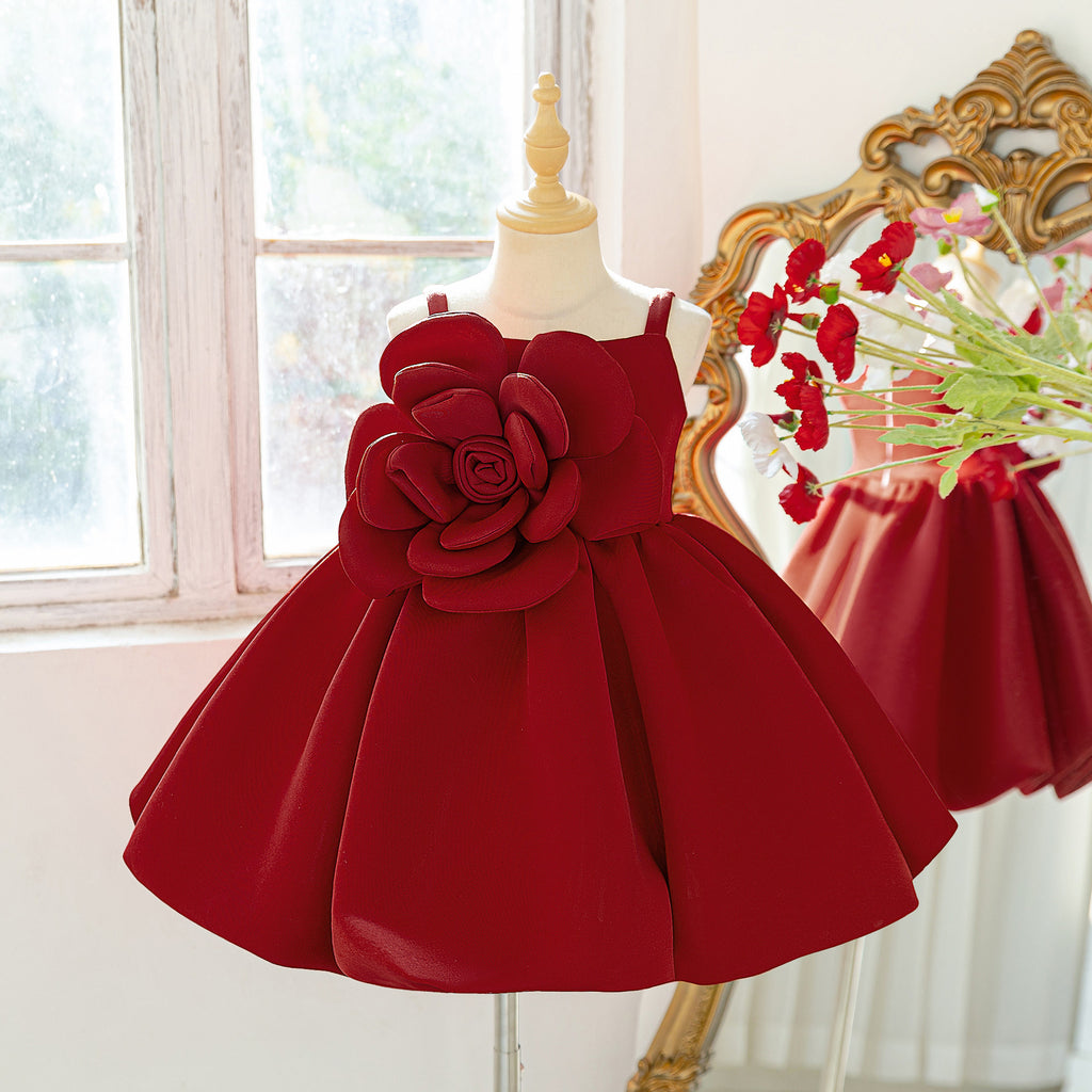 Side view of the deep red girls christmas dress with sleeveless straps and puffy skirt.