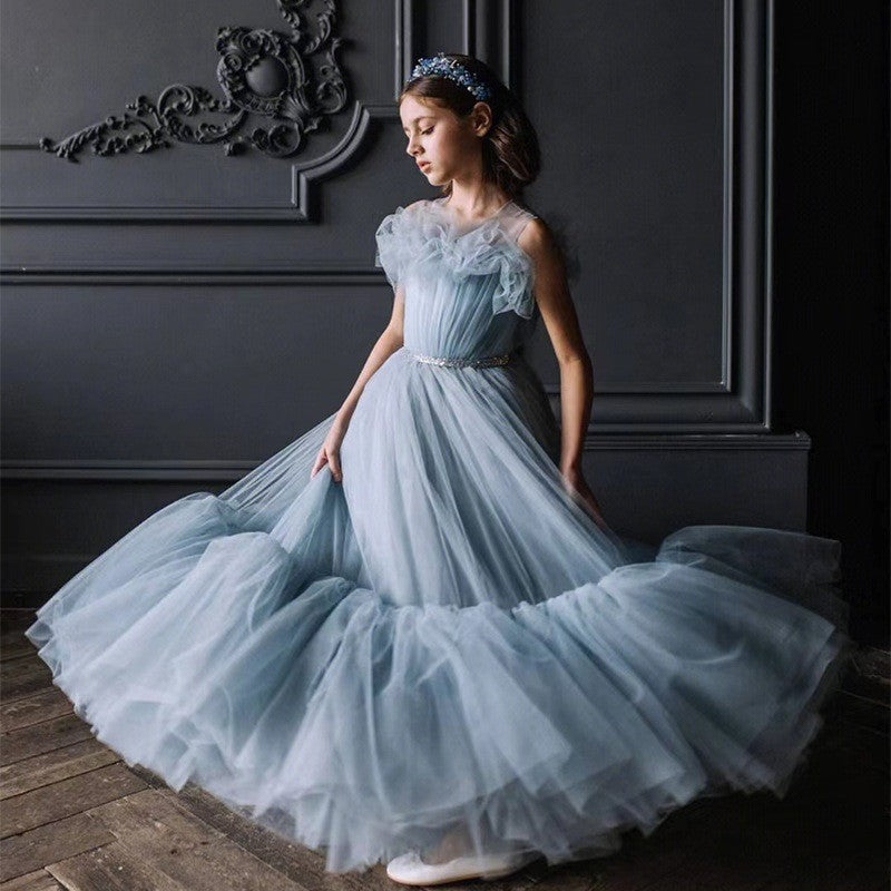 Dusty blue tiered tulle gown with the skirt in motion, side view, for a ceremony.