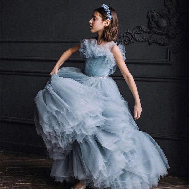 Layered tulle tiers on the dusty blue princess dress for girls, angled view.