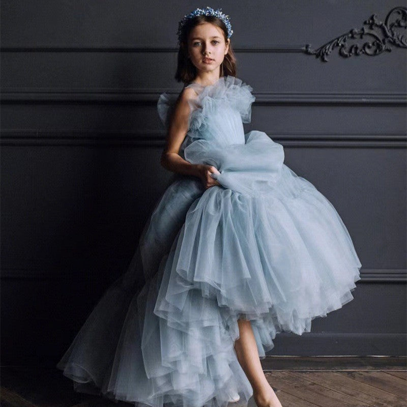 Dusty blue girls party dress showing the ruffled shoulder detail and full skirt, side view 2.