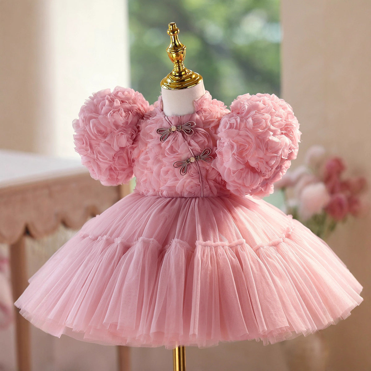 Dusty rose rosette princess dress for girls with puff sleeves and a tiered tulle skirt, front view, for a birthday party.