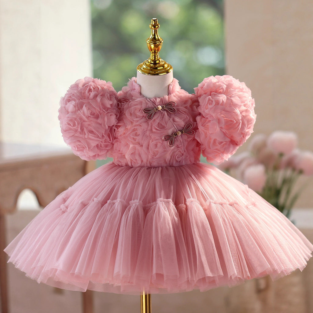 Rosette-covered bodice and mandarin collar on the dusty rose princess dress for girls, angled view.