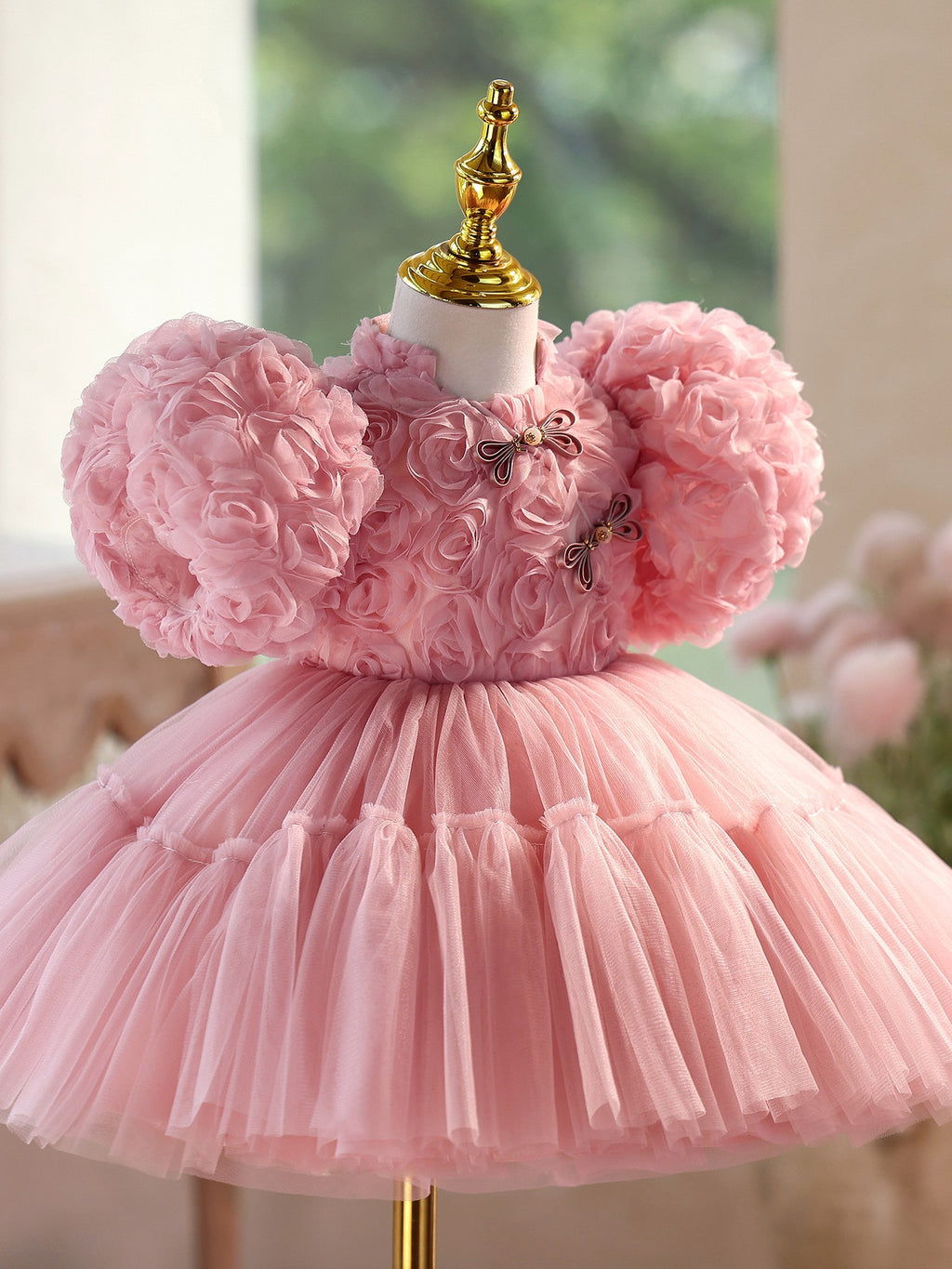 Close view of the frog button collar and rosette bodice on the dusty rose dress, side view 2.