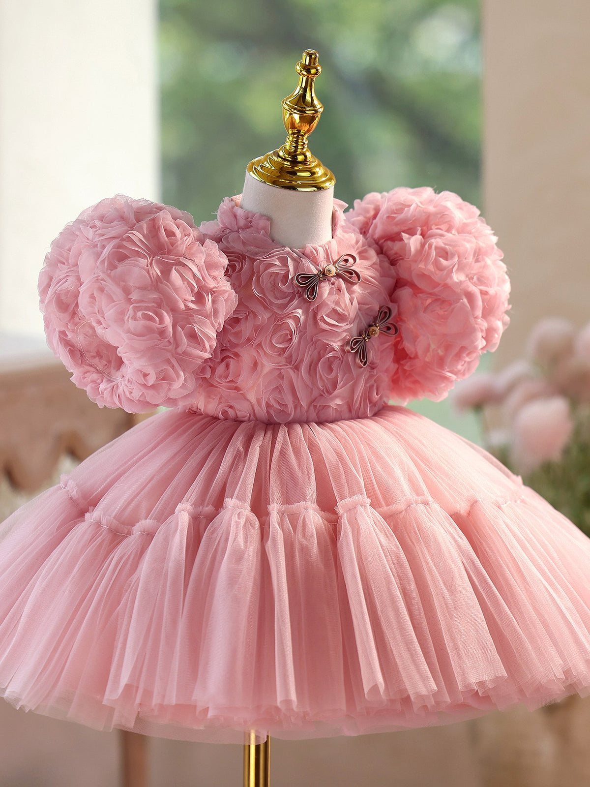 Close view of the frog button collar and rosette bodice on the dusty rose dress, side view 2.
