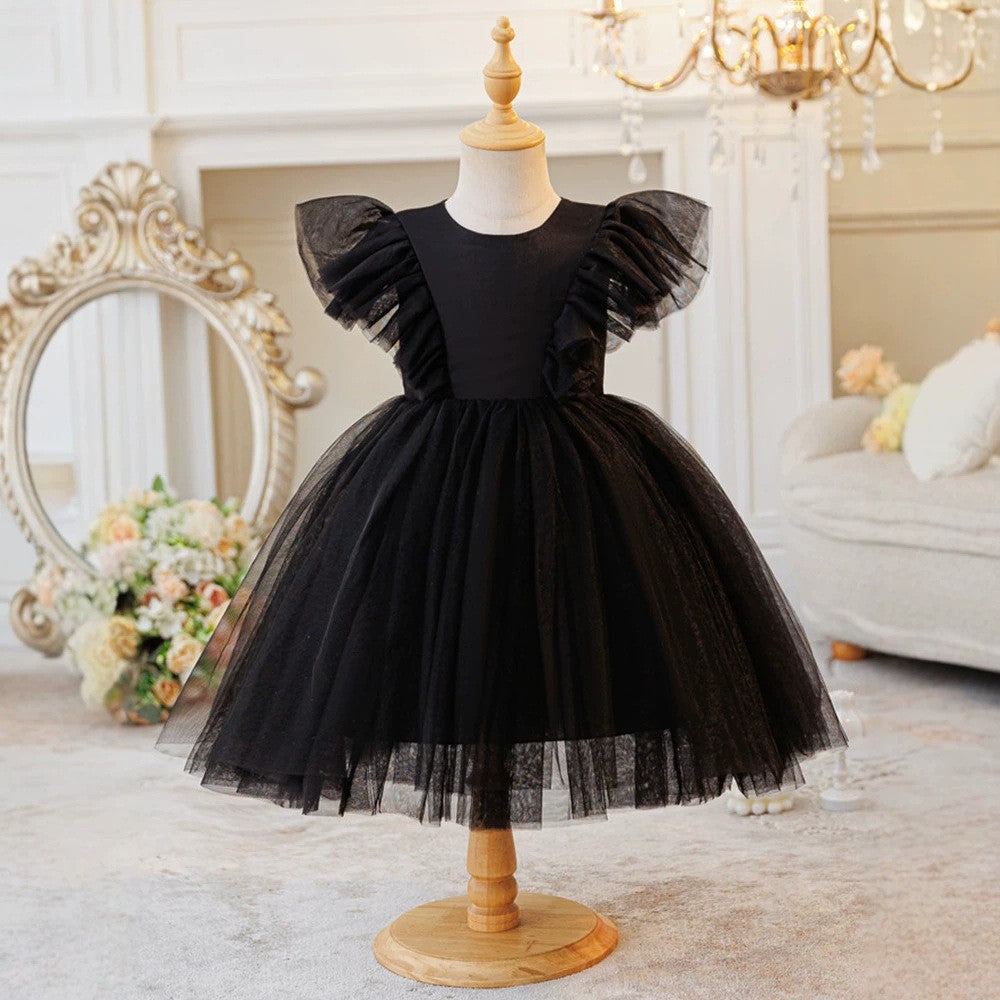 Black tulle girls party dress with flutter sleeves and a gathered skirt, front view.