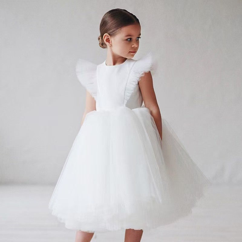 White tulle flower girl dress with flutter sleeves and a full skirt, front view, for a wedding.