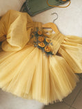 Golden yellow tulle girls tutu dress with long puff sleeves and 3D rosette bodice, designed for birthdays and flower girls.