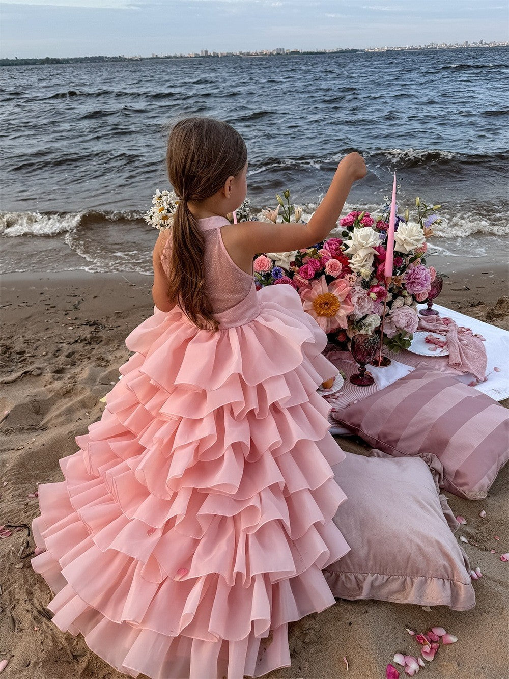Tiered organza ruffles on the blush pink flower girl dress, seaside view 2, for a summer ceremony.