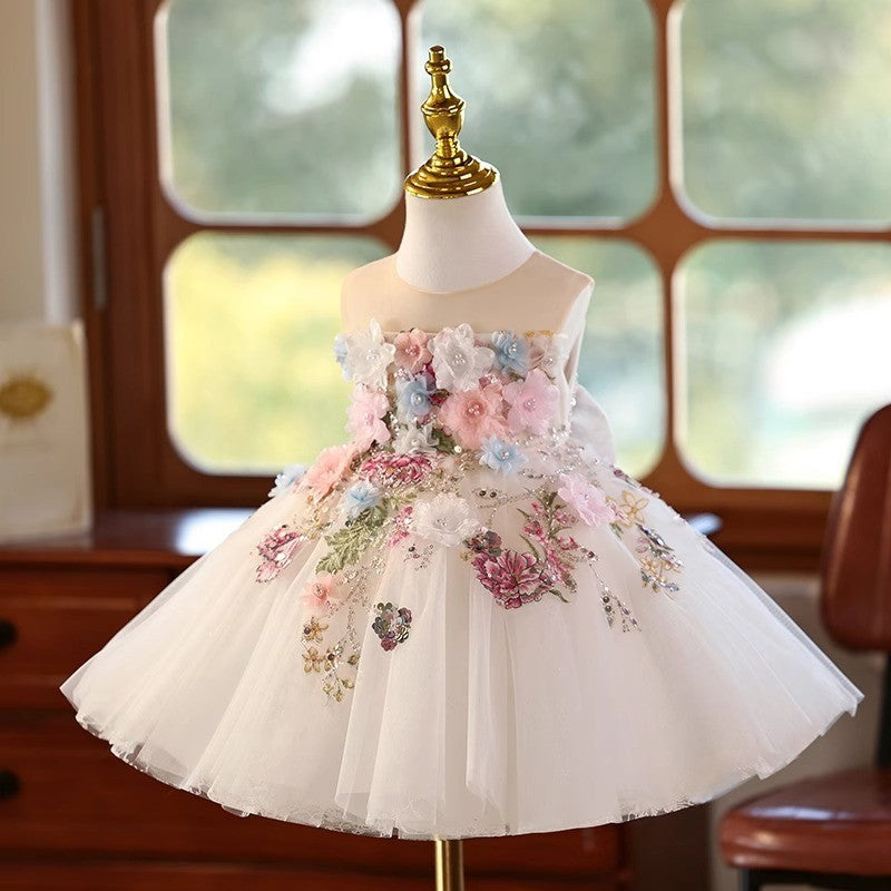 Ivory tulle flower girl dress with 3D floral appliqué across the bodice and skirt, front view, for weddings and ceremonies.