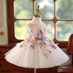Ivory 3D floral princess dress for girls showing the layered tulle skirt and the bow at the back, side view, for a birthday party.
