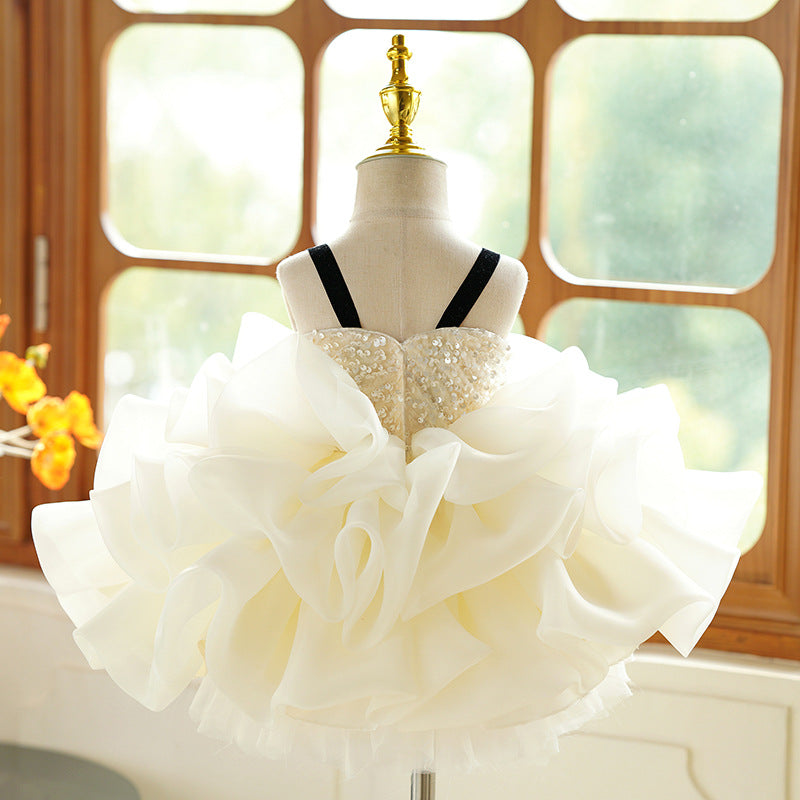 Ivory organza girls party dress back view with a sequin bodice and velvet straps, designed for birthday parties.