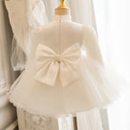 Ivory satin girls tutu dress back view with an oversized satin bow, designed for weddings.