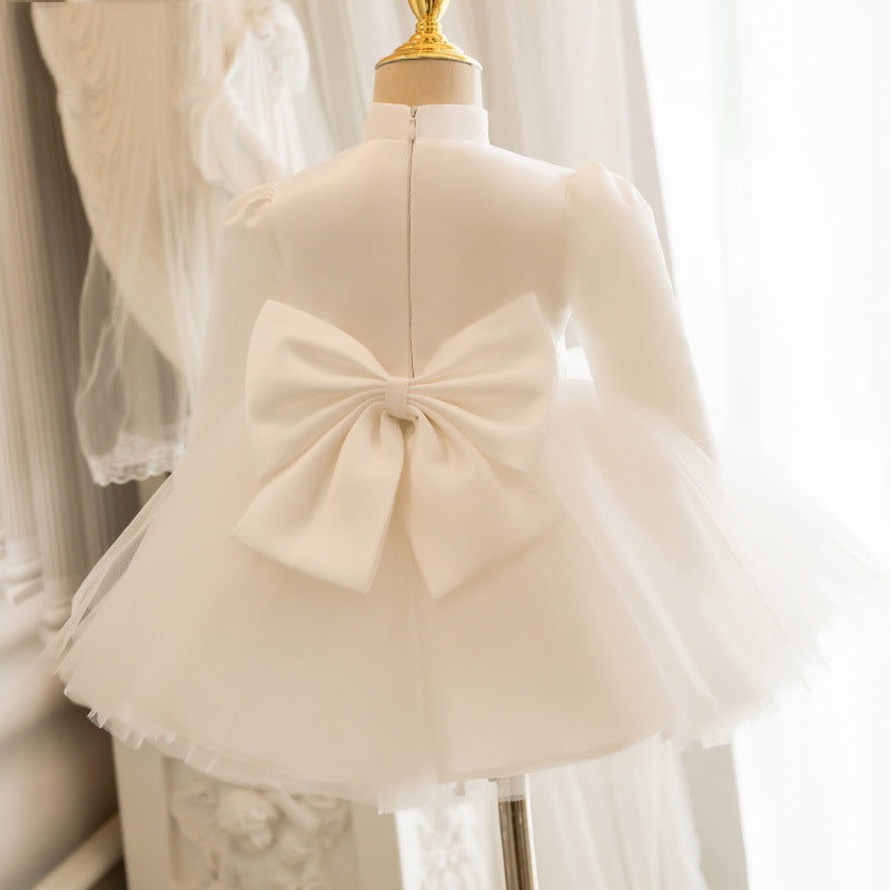 Ivory satin girls tutu dress back view with an oversized satin bow, designed for weddings.