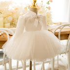 Ivory satin girls tutu dress with lace yoke and long sleeves, designed for first birthday parties.