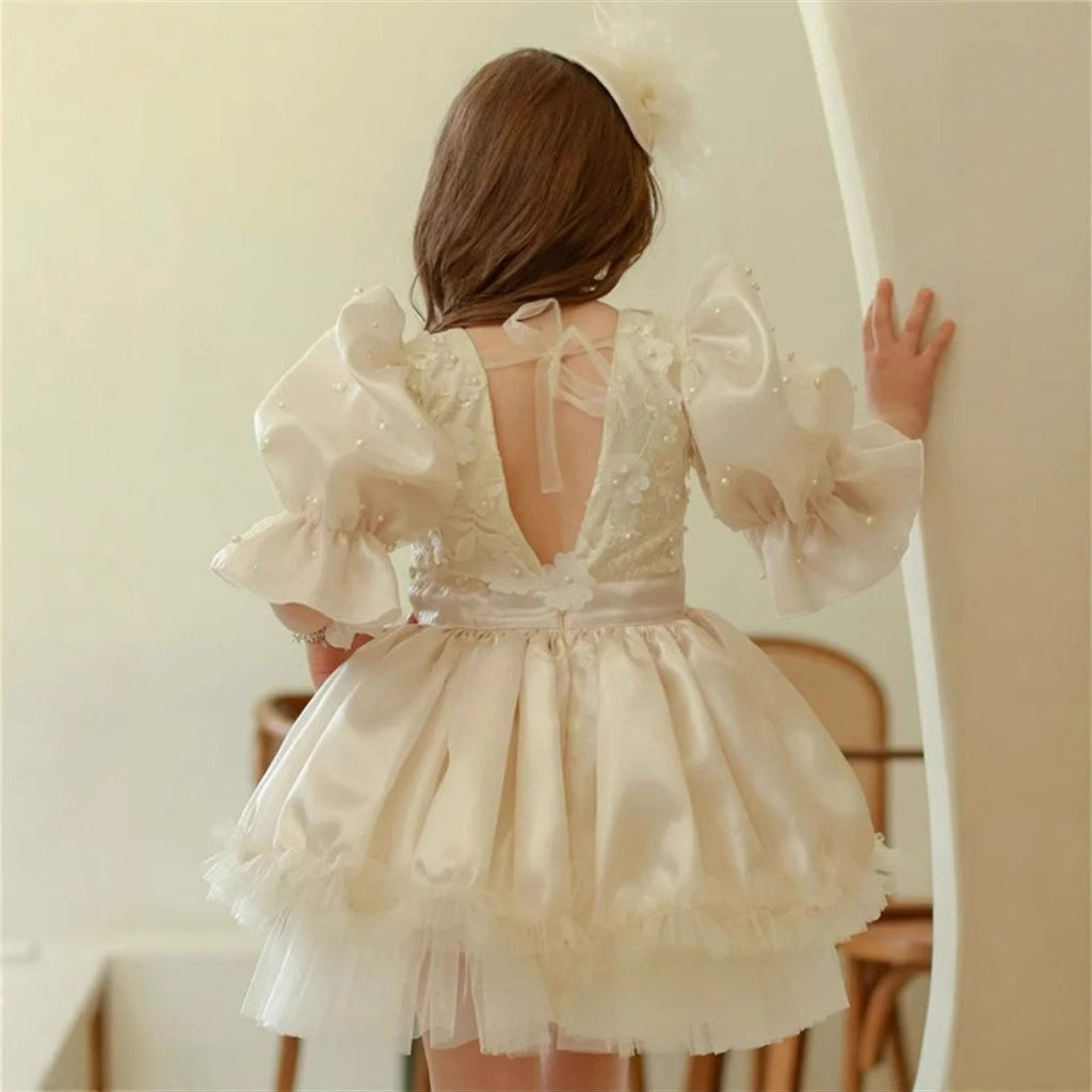 Open V back with a ribbon tie on the ivory flower girl dress, back view.