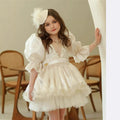 Ivory pearl lace flower girl dress with puff sleeves and a satin sash, front view, for a wedding.