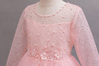 Pink lace and tulle girls gown with a pearl-beaded lace bodice and round neckline, designed for weddings and flower girls.