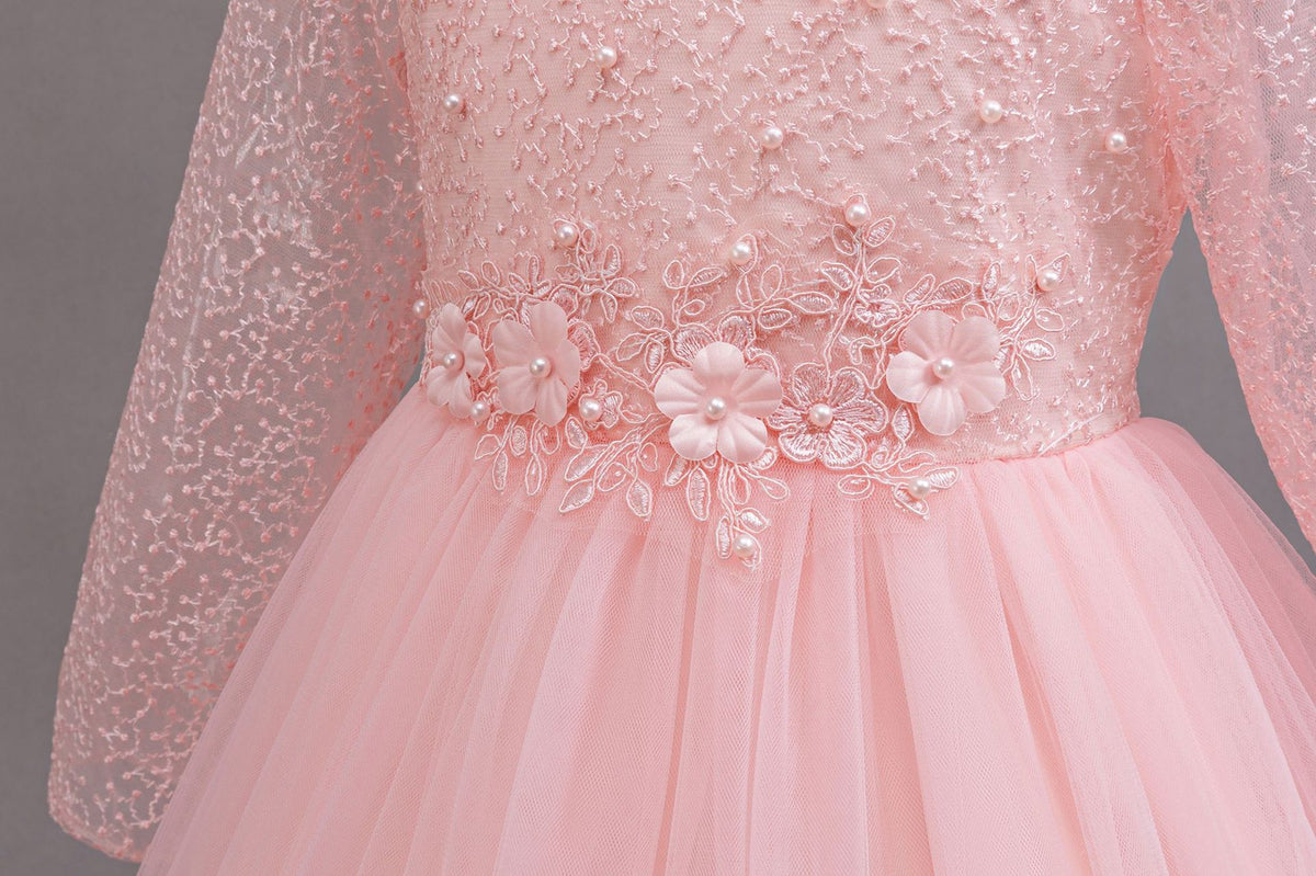 Pink lace and tulle girls gown with 3D fabric flowers and pearls at the waist, designed for weddings and flower girls.