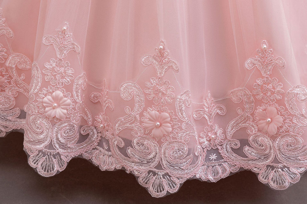 Pink lace and tulle girls gown with an embroidered floral lace hem border, designed for weddings and flower girls.