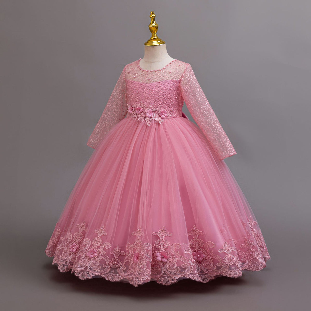 Mauve lace and tulle girls gown with long lace sleeves and a floral waist, designed for weddings and flower girls.