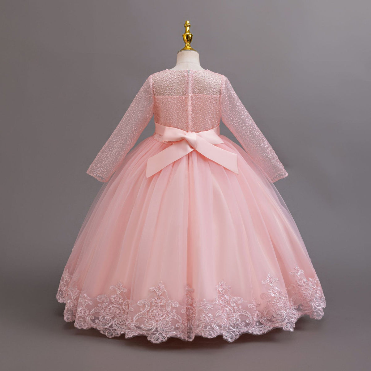 Pink lace and tulle girls gown with a satin back bow and lace hem, designed for weddings and flower girls.