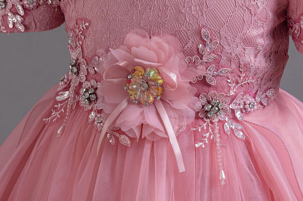 Pink lace girls gown close-up of the 3D fabric flower and beaded lace waist, designed for formal events.