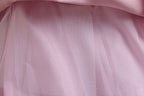 Pink lace girls gown close-up of the soft tulle skirt layers, designed for weddings and parties.
