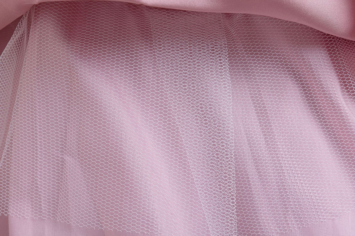 Pink lace girls gown close-up of the soft tulle skirt layers, designed for weddings and parties.
